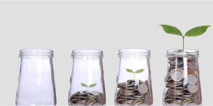 Four jars of coins with last jar with a plant